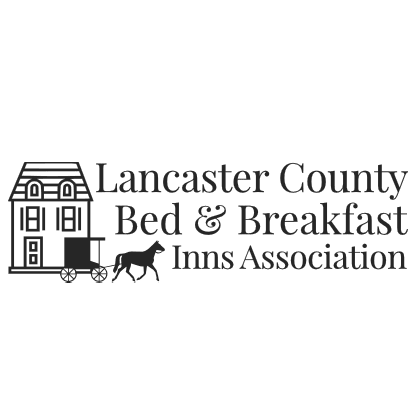 Logo of the Lancaster County Bed & Breakfast Inns Association featuring a house and horse-drawn carriage.