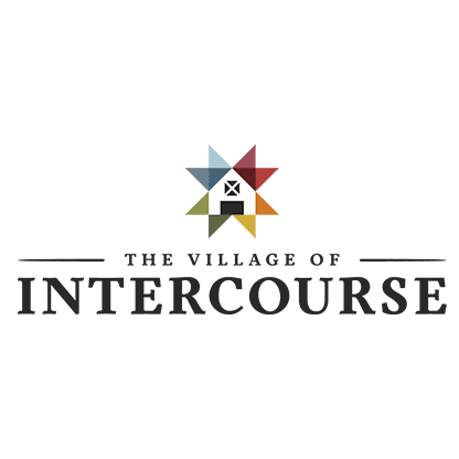 Logo of The Village of Intercourse featuring a colorful star design above the text.