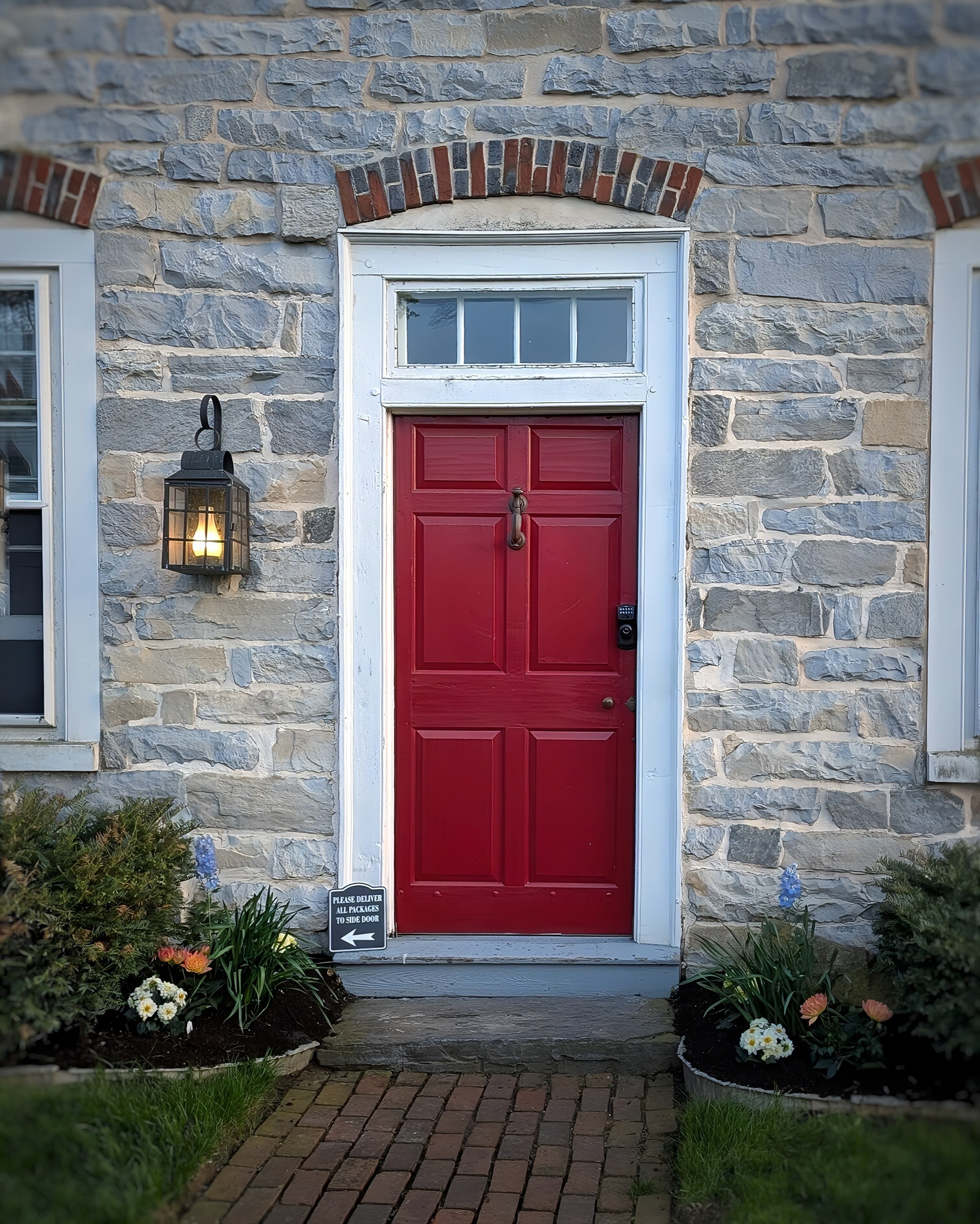 Red entry door and limestone front exterior of our inn